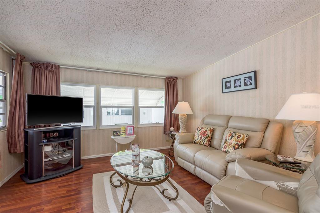 2331 Belleair Road, Unit 514 Clearwater, FL 33764 - Photo 11 of 39 a living room with furniture and a flat screen tv