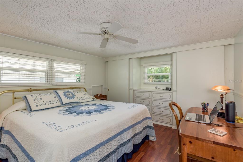 2331 Belleair Road, Unit 514 Clearwater, FL 33764 - Photo 13 of 39 a bedroom with a bed a table and chair