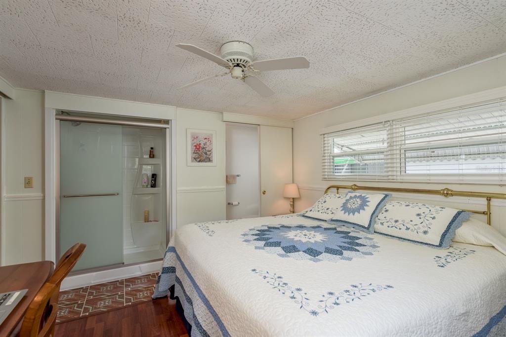 2331 Belleair Road, Unit 514 Clearwater, FL 33764 - Photo 14 of 39 a bedroom with a bed and wooden floor