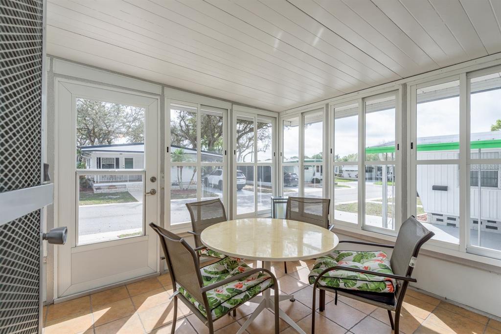 2331 Belleair Road, Unit 514 Clearwater, FL 33764 - Photo 19 of 39 a dining room with furniture window and outside view