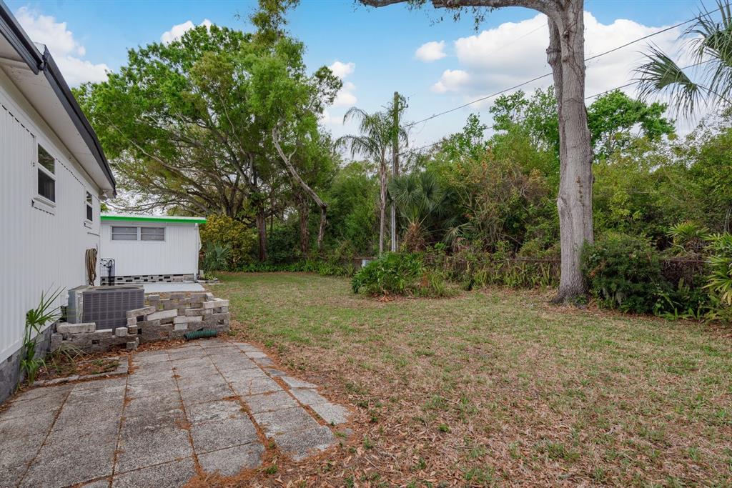 2331 Belleair Road, Unit 514 Clearwater, FL 33764 - Photo 26 of 39 a backyard of a house with lots of green space