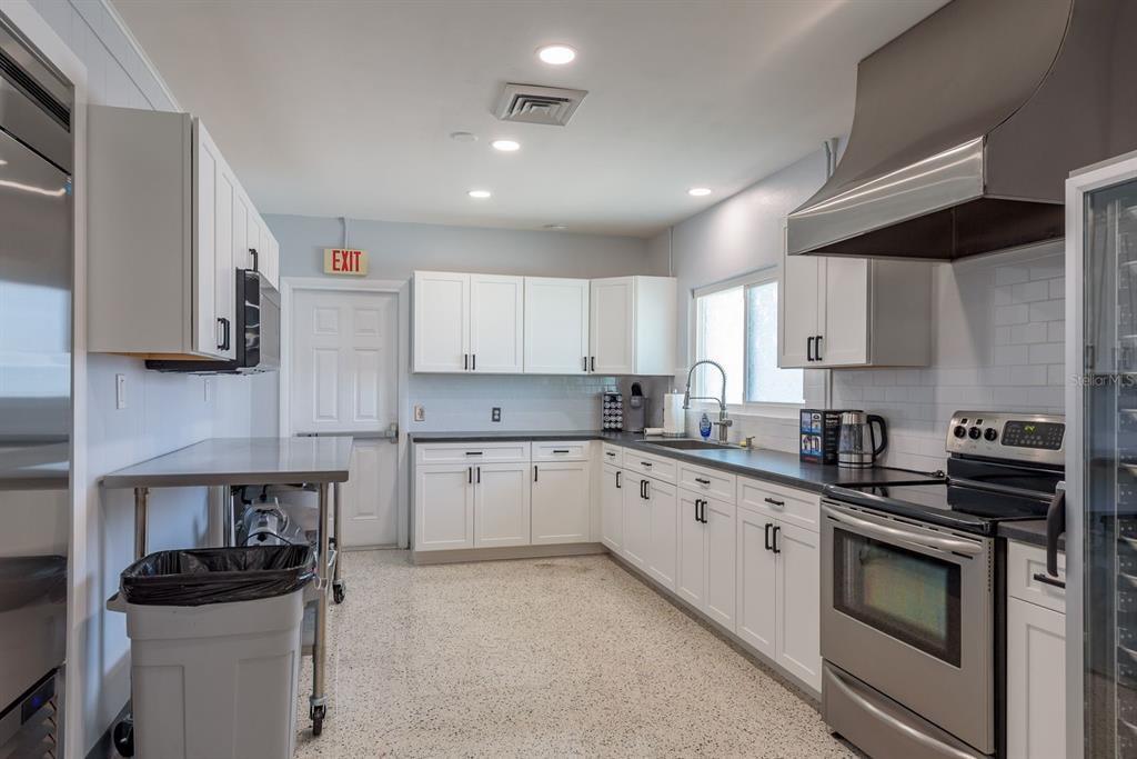 2331 Belleair Road, Unit 514 Clearwater, FL 33764 - Photo 35 of 39 a kitchen with a sink stove and cabinets
