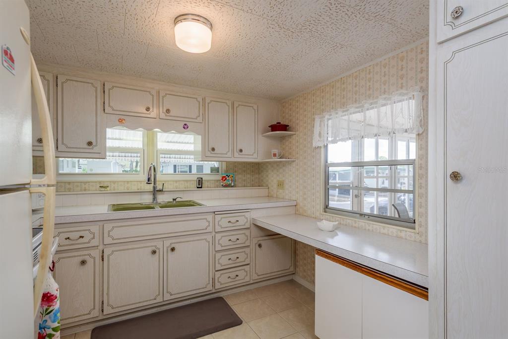 2331 Belleair Road, Unit 514 Clearwater, FL 33764 - Photo 6 of 39 a kitchen with cabinets appliances a sink and a window