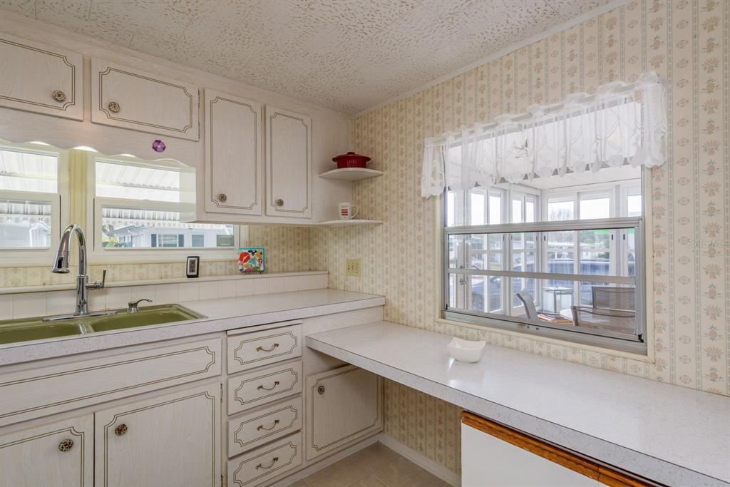2331 Belleair Road, Unit 514 Clearwater, FL 33764 - Photo 8 of 39 a kitchen with cabinets appliances a sink and a window