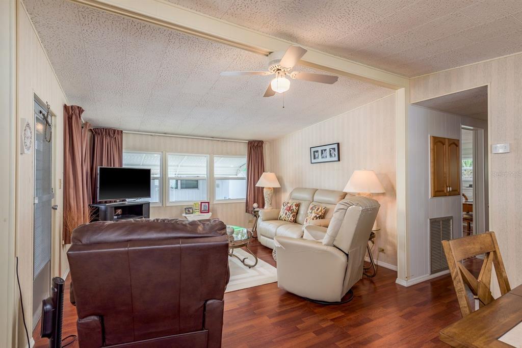 2331 Belleair Road, Unit 514 Clearwater, FL 33764 - Photo 9 of 39 a living room with furniture and a flat screen tv