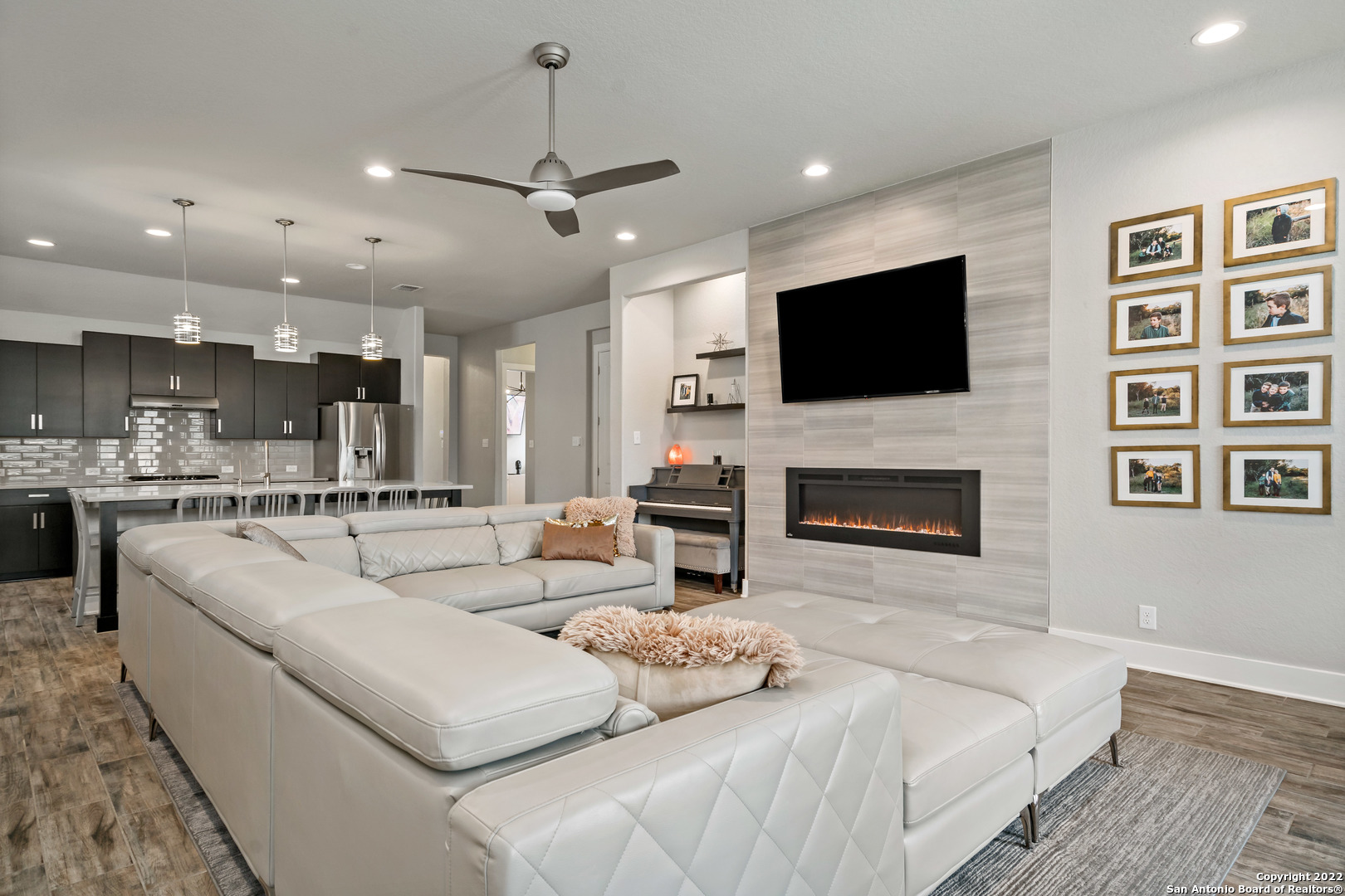 a living room with fireplace furniture and a flat screen tv
