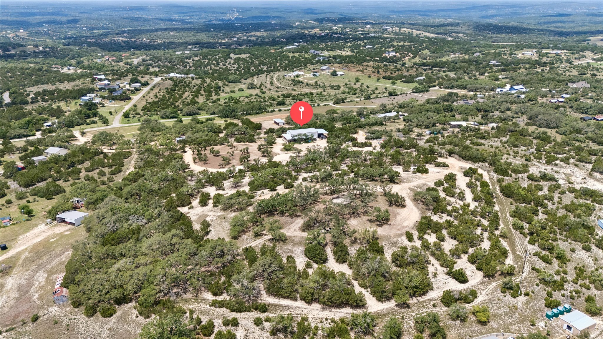 6411 West Fitzhugh Road Dripping Springs, TX 78620 - Photo 3 of 34 Expansive treed lot featuring a single-story dwelling with a metal roof