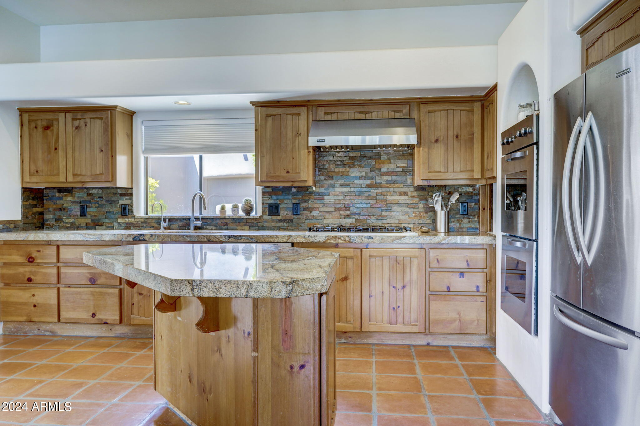 10468 East Quartz Rock Road Scottsdale, AZ 85255 - Photo 12 of 58 a kitchen with stainless steel appliances granite countertop a sink stove and refrigerator