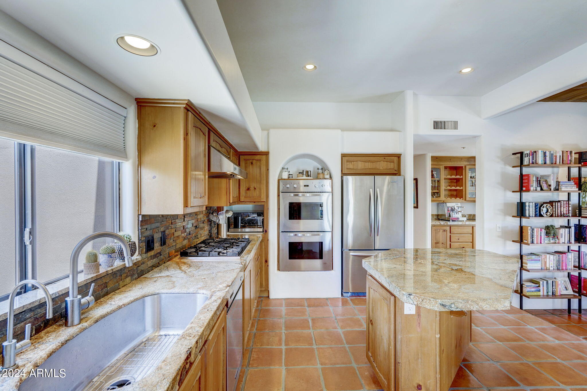 10468 East Quartz Rock Road Scottsdale, AZ 85255 - Photo 13 of 58 a kitchen with stainless steel appliances granite countertop a sink and a refrigerator