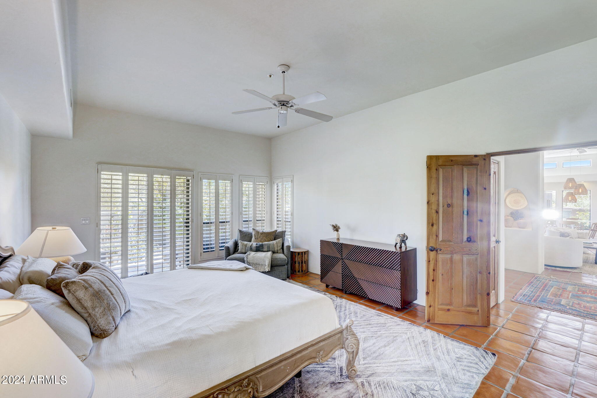 10468 East Quartz Rock Road Scottsdale, AZ 85255 - Photo 15 of 58 a bed room with a bed and a chandelier