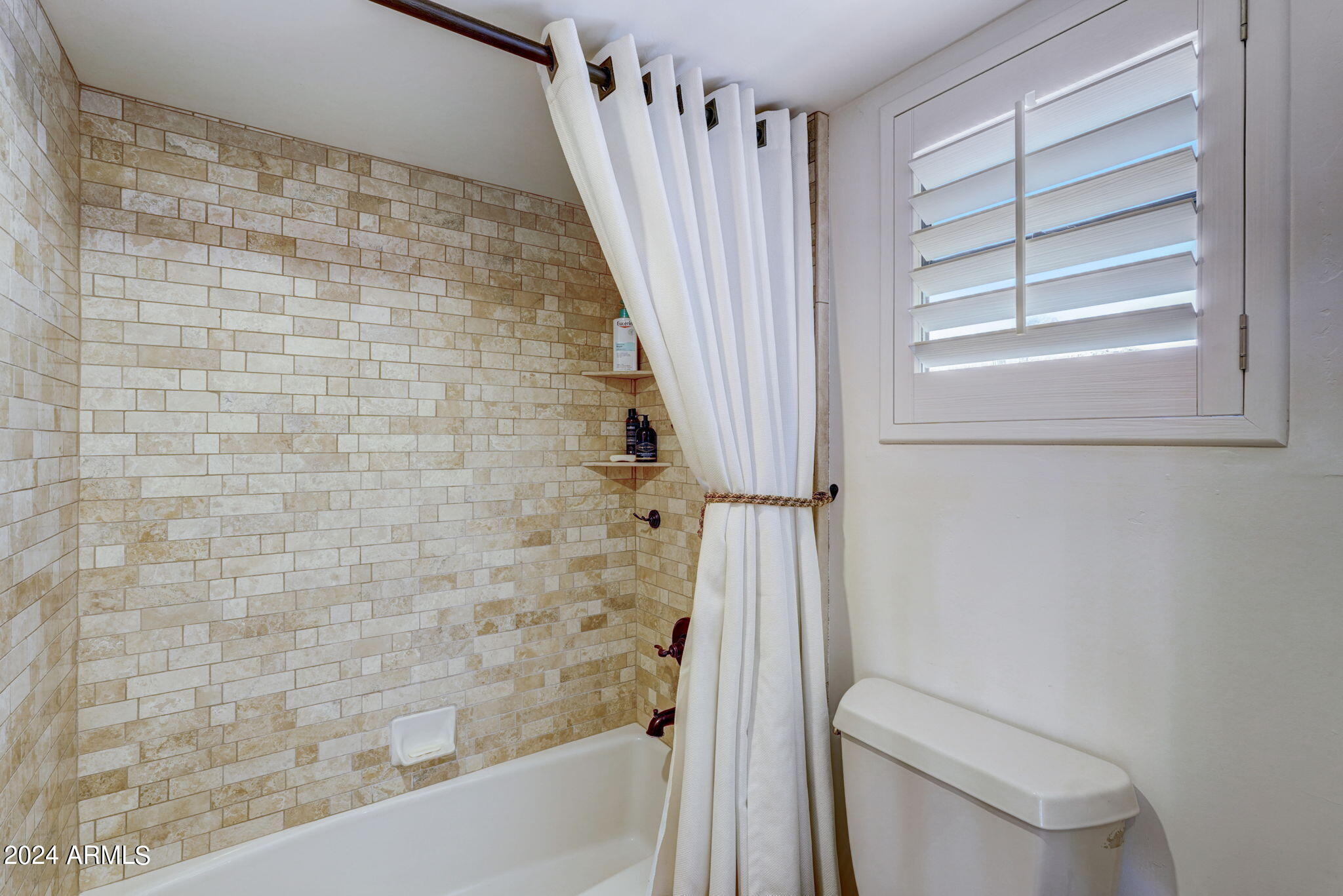 10468 East Quartz Rock Road Scottsdale, AZ 85255 - Photo 32 of 58 a bathroom with a toilet and a shower