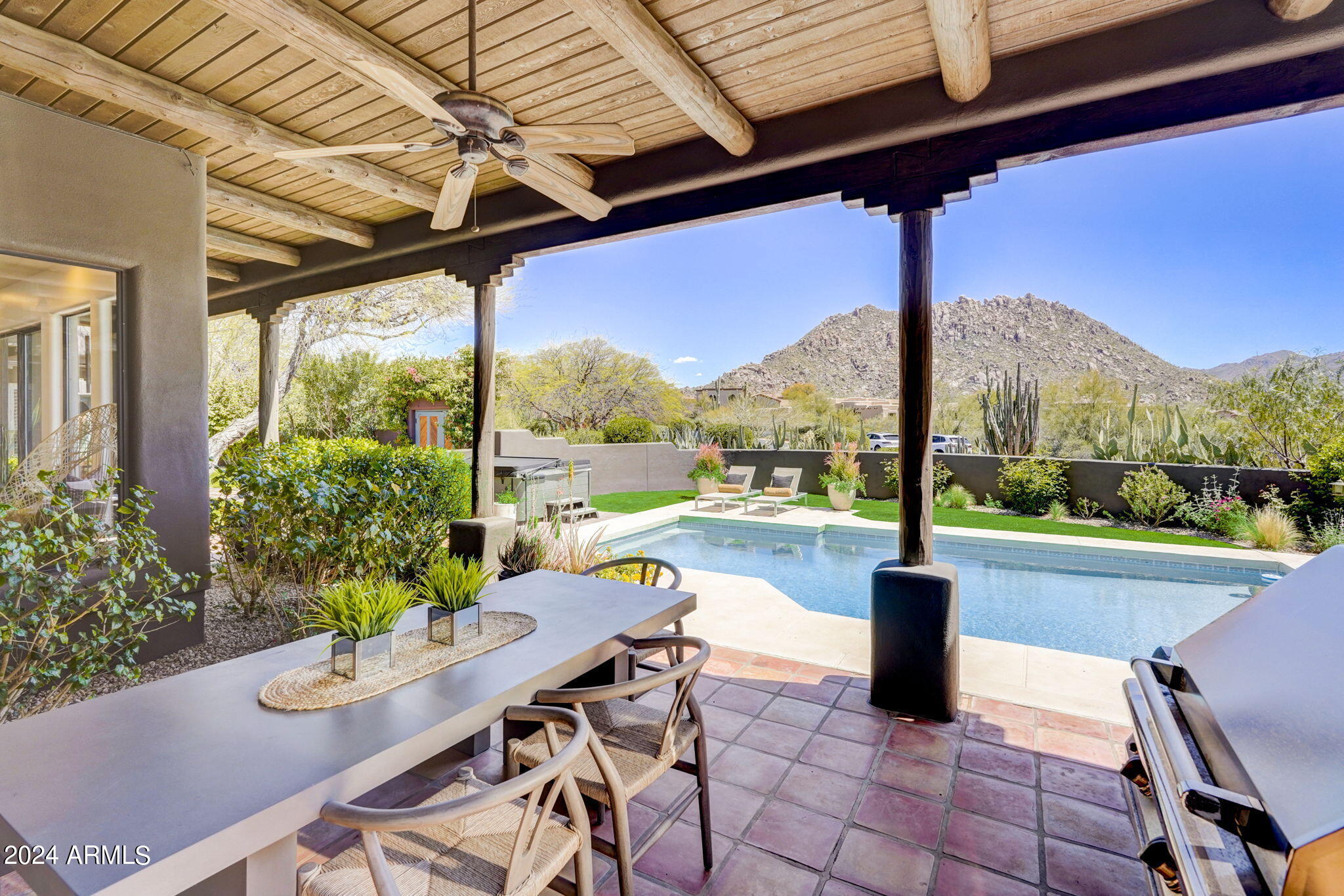 10468 East Quartz Rock Road Scottsdale, AZ 85255 - Photo 36 of 58 a view of a patio with a table chairs and a table