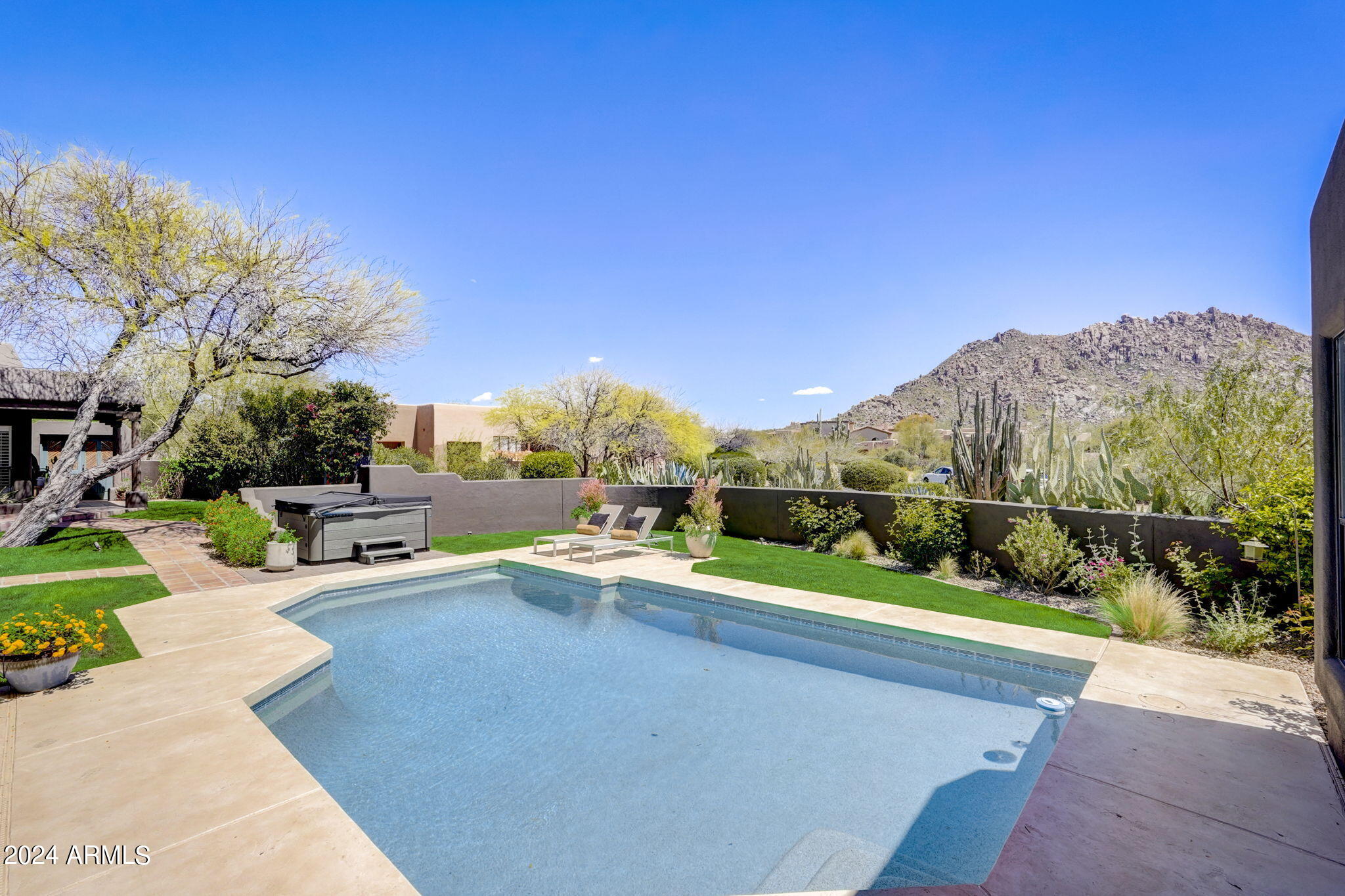 10468 East Quartz Rock Road Scottsdale, AZ 85255 - Photo 39 of 58 a view of a patio with couches and table and chairs under an umbrella