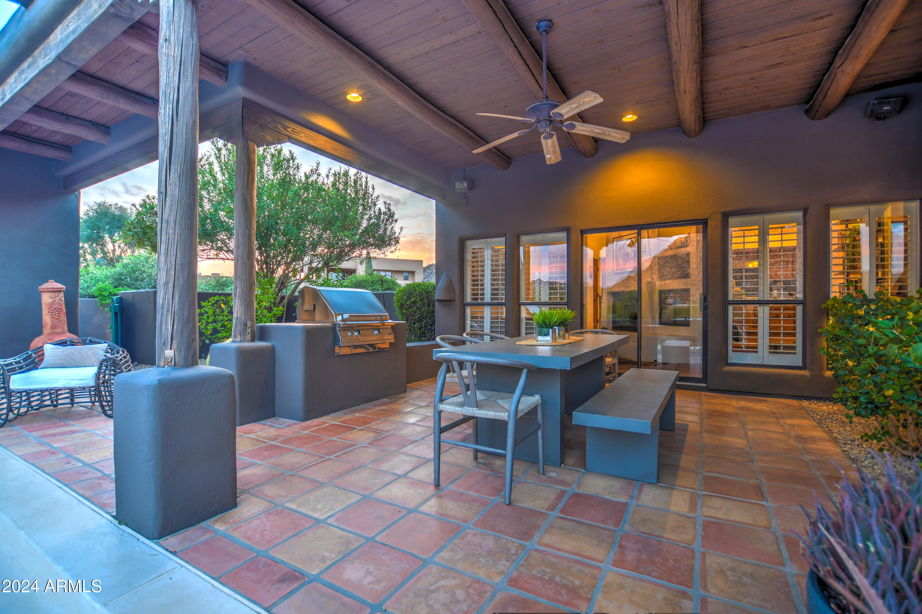 10468 East Quartz Rock Road Scottsdale, AZ 85255 - Photo 45 of 58 a view of a patio with a dining table and chairs