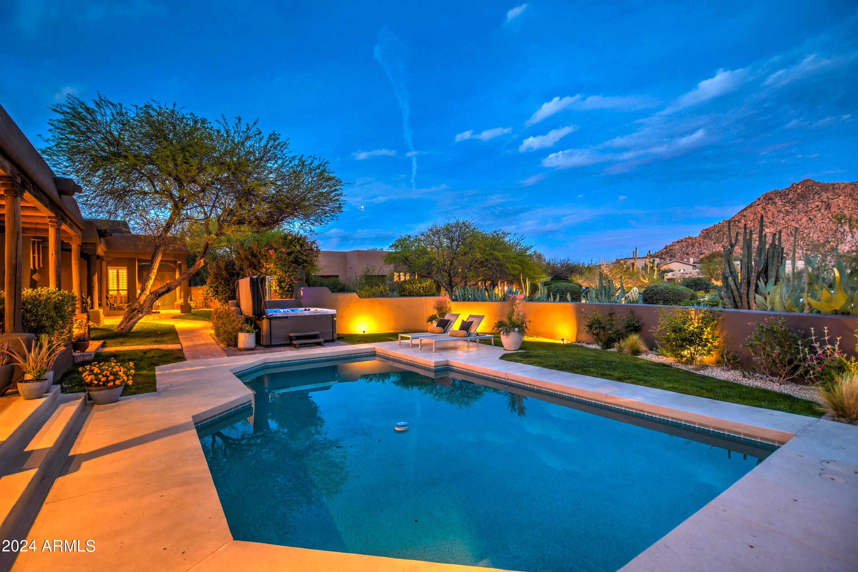 10468 East Quartz Rock Road Scottsdale, AZ 85255 - Photo 47 of 58 a view of a swimming pool with a table and chairs