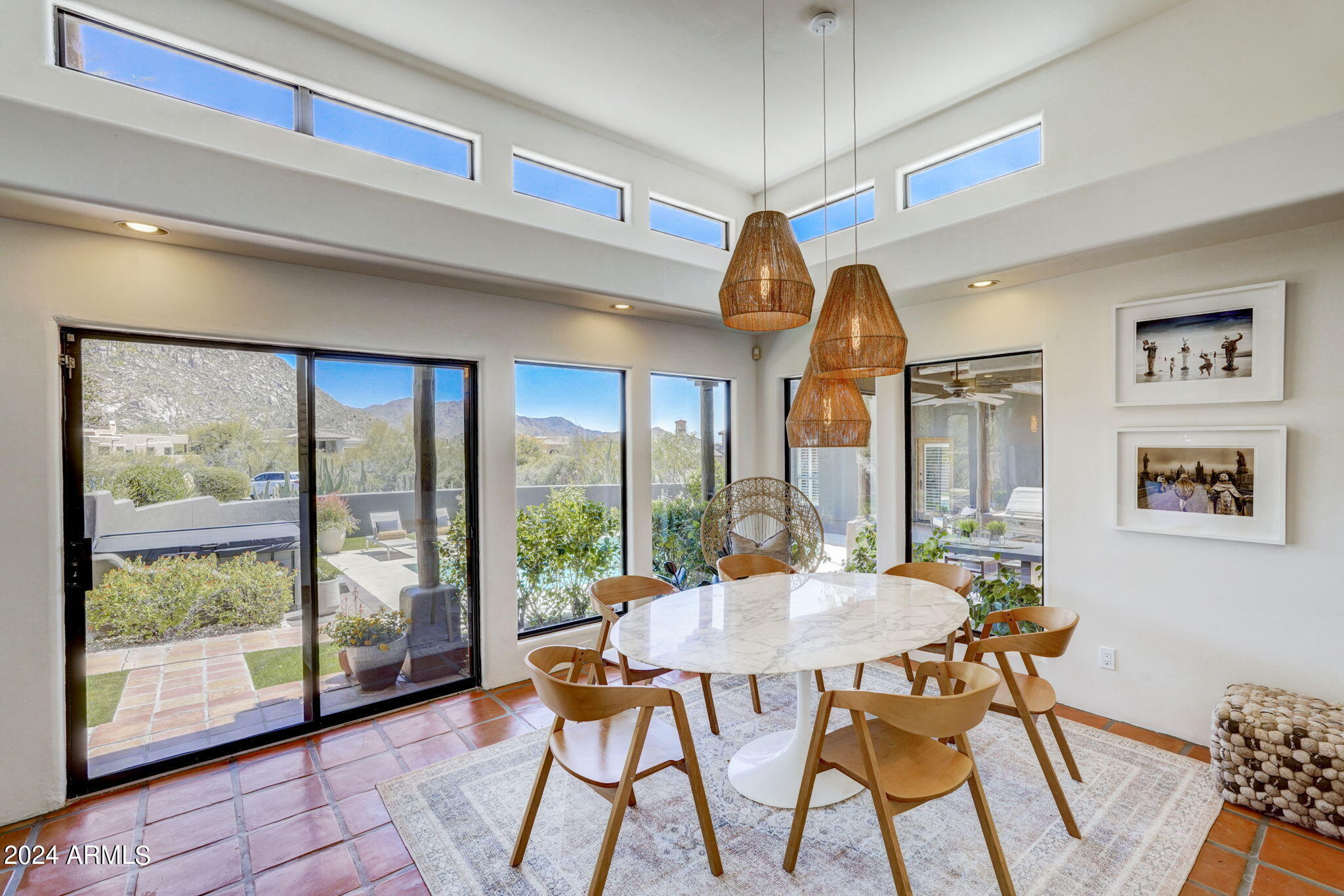 10468 East Quartz Rock Road Scottsdale, AZ 85255 - Photo 10 of 58 a view of a dining room with furniture large windows and wooden floor
