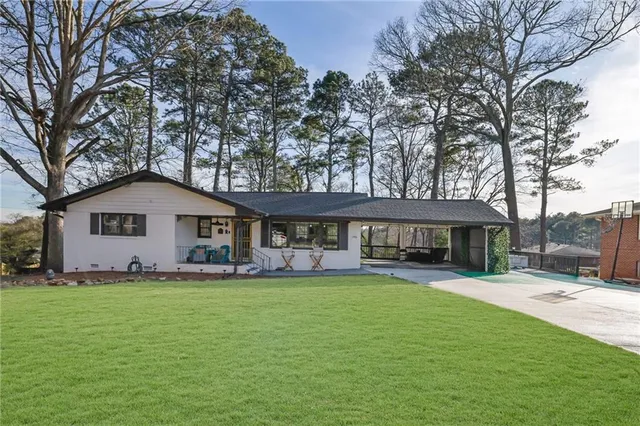 a view of a house with a yard porch and sitting area