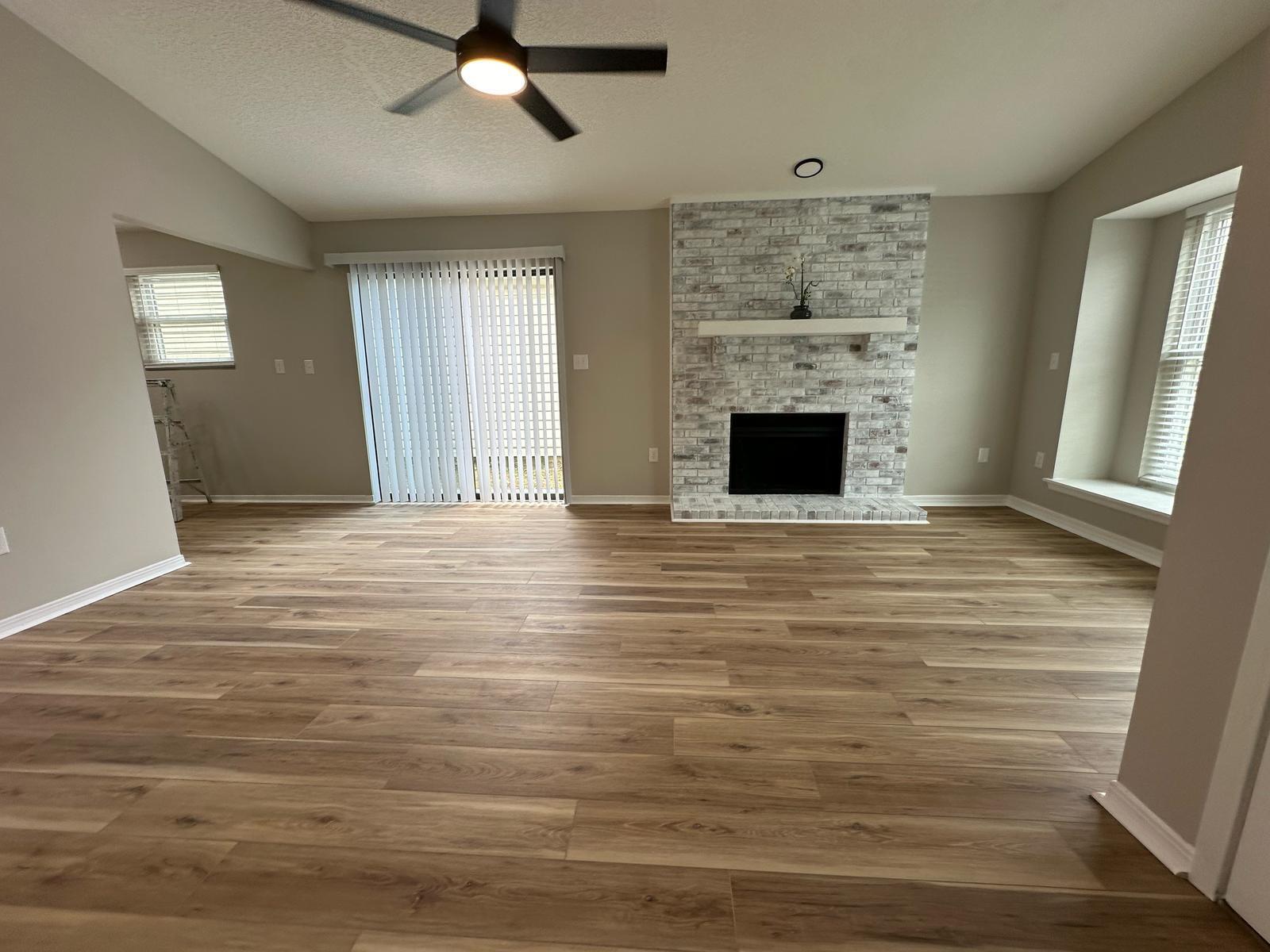 1 Kelly Way Valparaiso, FL 32580 - Photo 11 of 18 a view of a livingroom with a fireplace a ceiling fan and windows