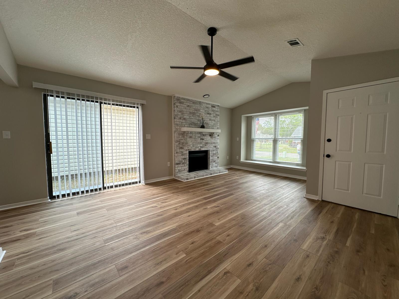 1 Kelly Way Valparaiso, FL 32580 - Photo 13 of 18 a view of an empty room with wooden floor fireplace and a window