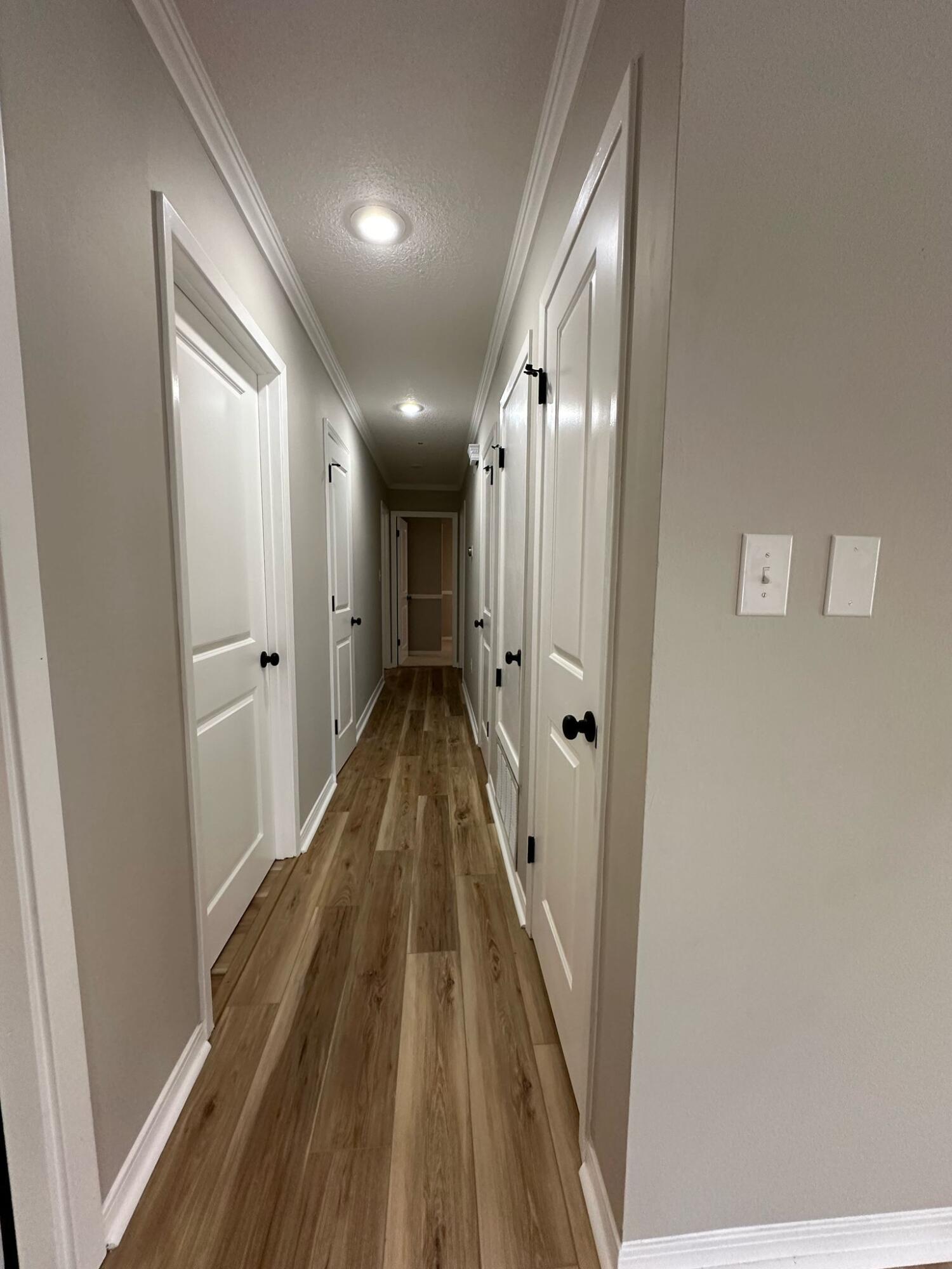 1 Kelly Way Valparaiso, FL 32580 - Photo 14 of 18 a view of a hallway with wooden floor and staircase