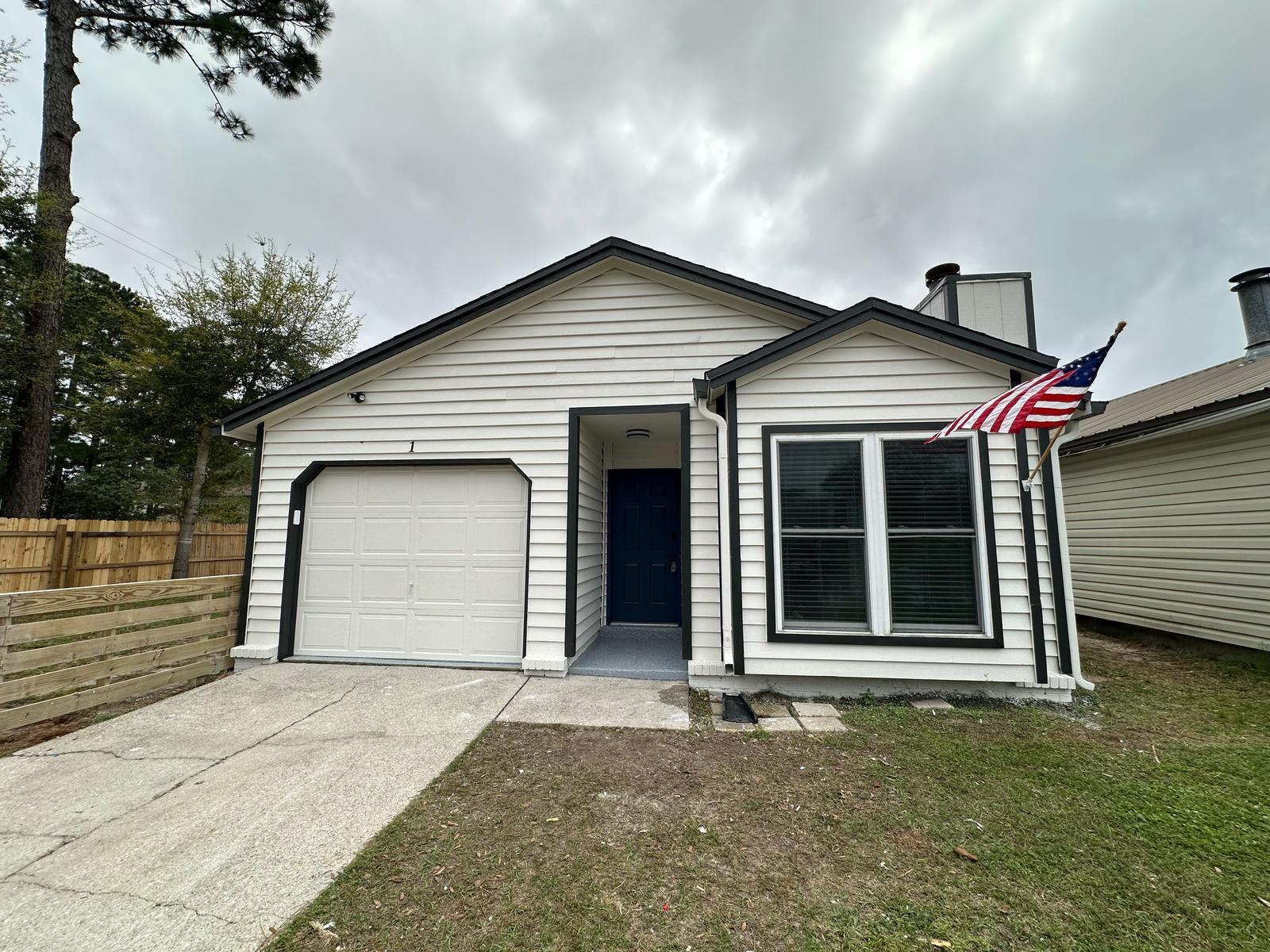 1 Kelly Way Valparaiso, FL 32580 - Photo 2 of 18 a front view of a house with a yard and garage