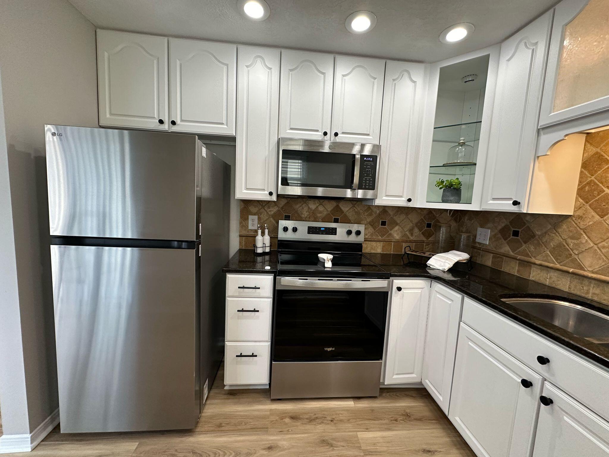 1 Kelly Way Valparaiso, FL 32580 - Photo 5 of 18 a kitchen with stainless steel appliances granite countertop a refrigerator a stove a sink and a microwave