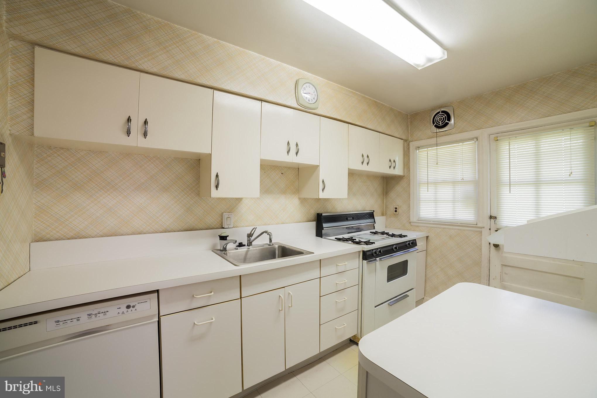 3908 Clarinth Road Baltimore, MD 21215 - Photo 11 of 23 a kitchen with a sink stove and cabinets