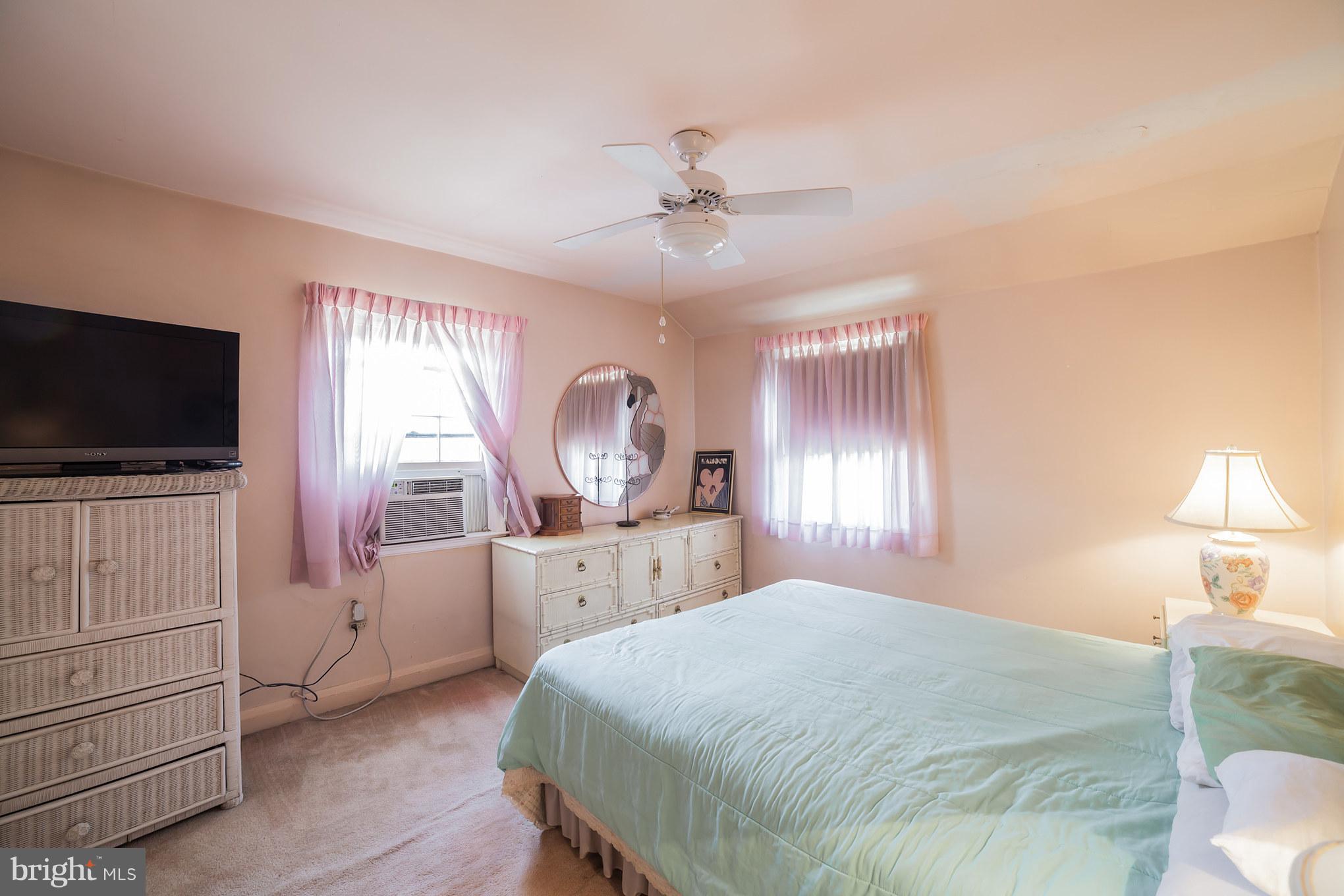 3908 Clarinth Road Baltimore, MD 21215 - Photo 16 of 23 a bedroom with a bed and a flat screen tv