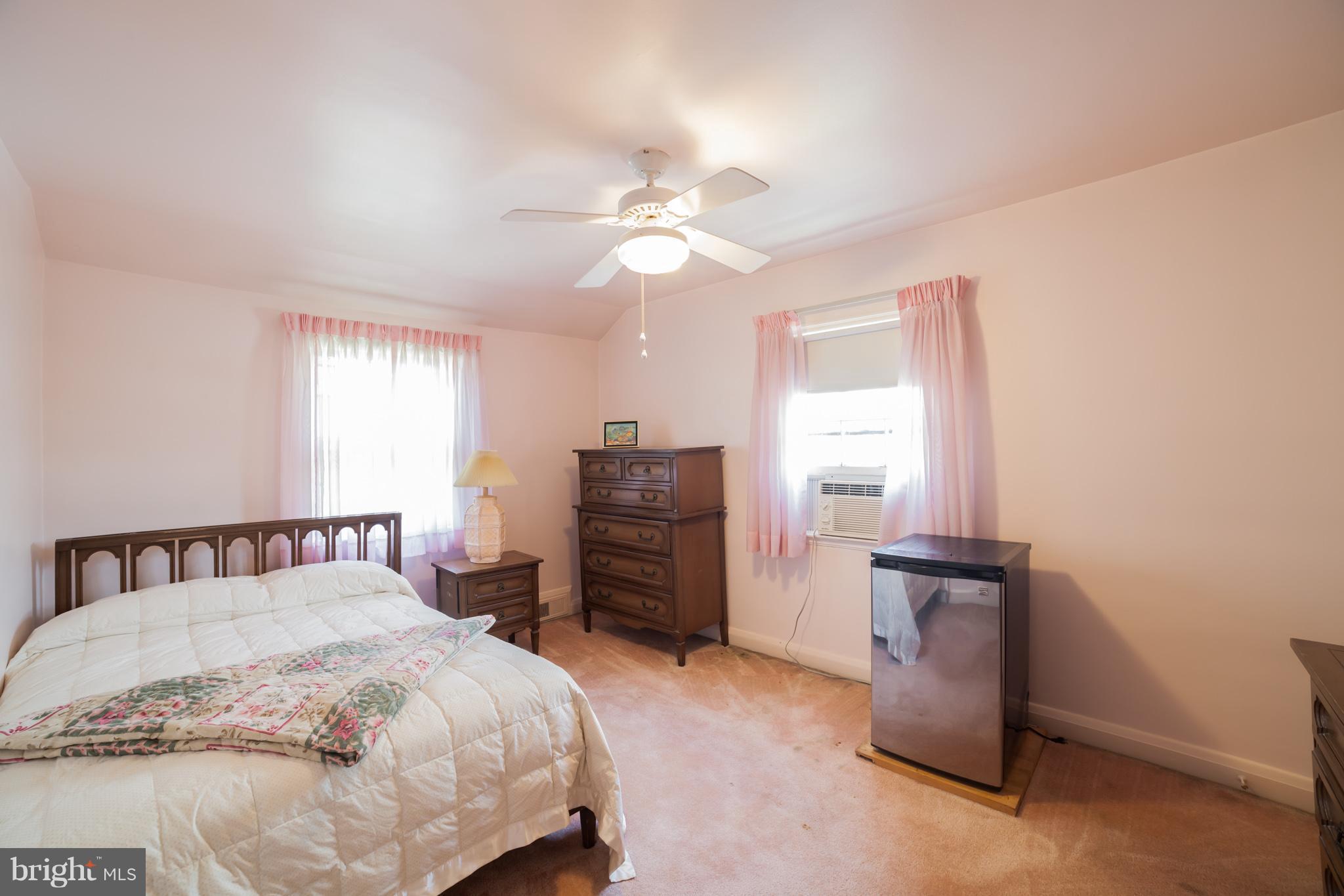 3908 Clarinth Road Baltimore, MD 21215 - Photo 18 of 23 a bedroom with a bed and a chandelier