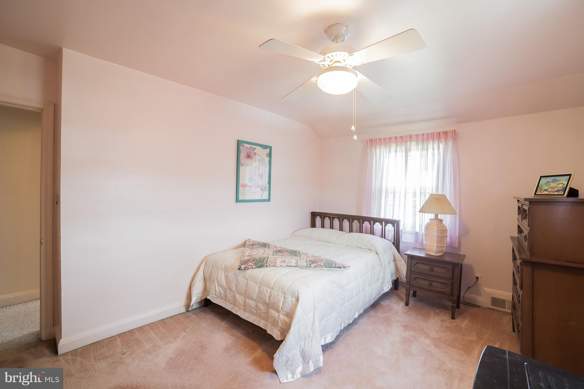 3908 Clarinth Road Baltimore, MD 21215 - Photo 19 of 23 a bed room with a bed and a chandelier