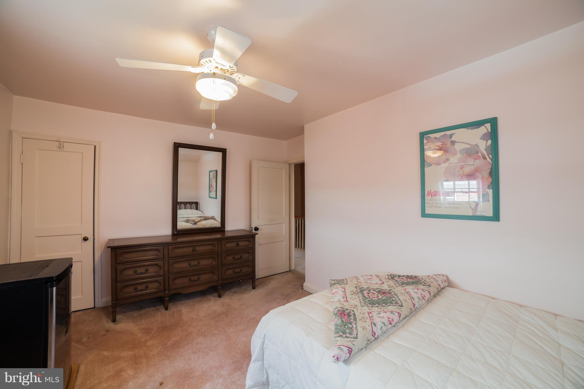 3908 Clarinth Road Baltimore, MD 21215 - Photo 20 of 23 a bedroom with a bed and a chandelier