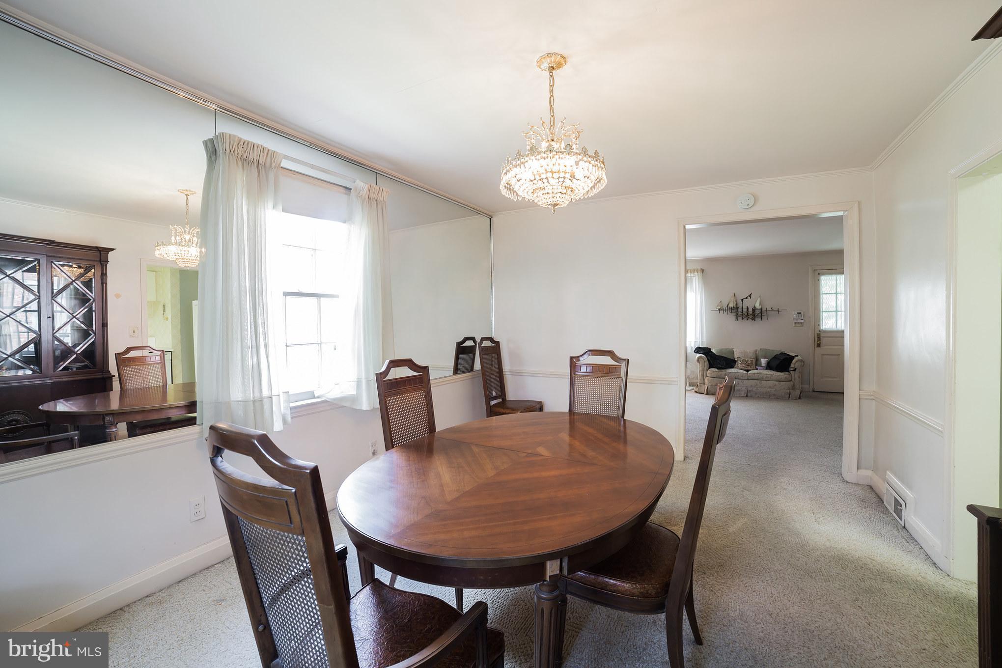 3908 Clarinth Road Baltimore, MD 21215 - Photo 9 of 23 a view of a dining room with furniture window and wooden floor