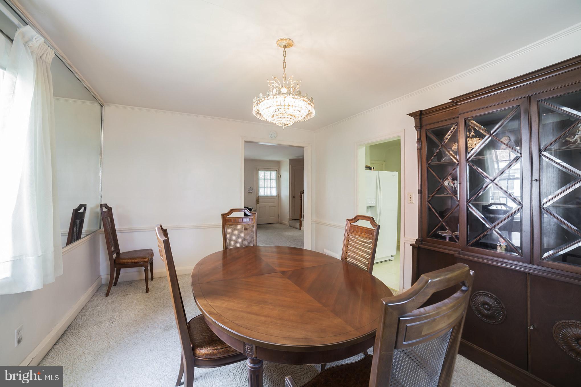3908 Clarinth Road Baltimore, MD 21215 - Photo 10 of 23 a view of a dining room with furniture and chandelier