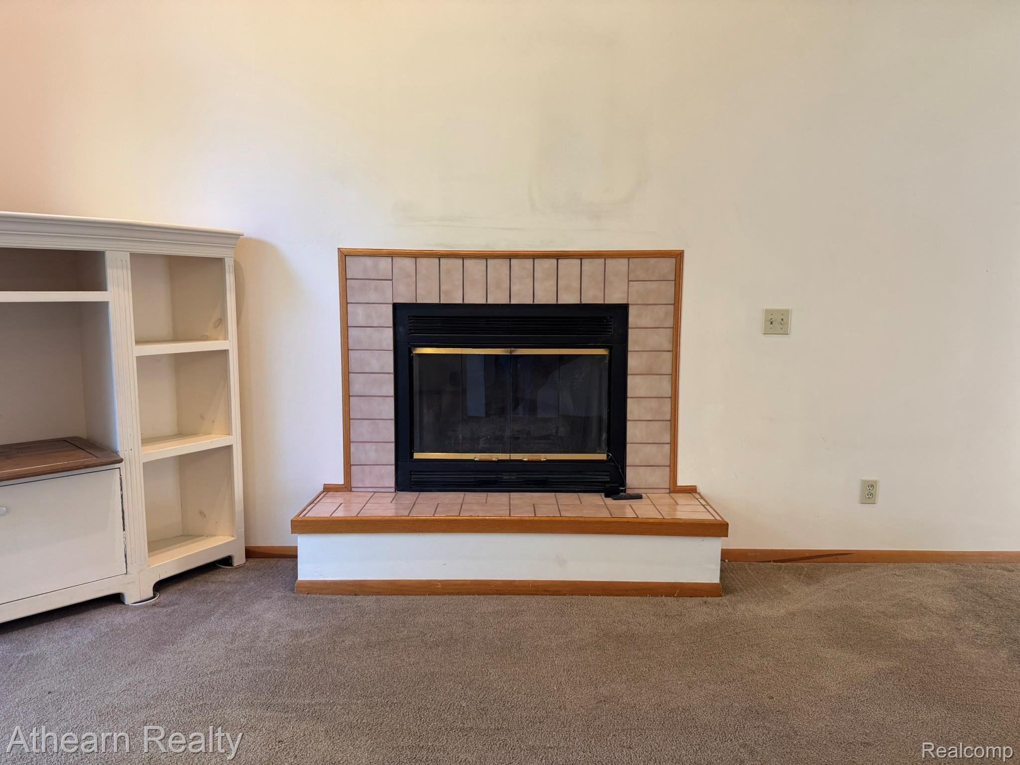 11449 Torrey Road Fenton, MI 48430 - Photo 10 of 30 Fireplace featuring a tiled surround and hearth, with a metal insert