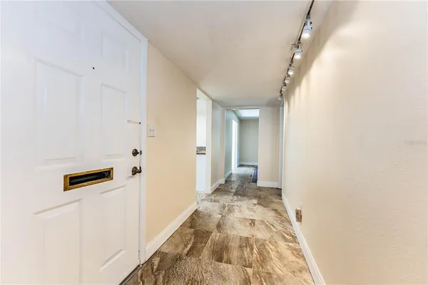 a view of a hallway with wooden floor
