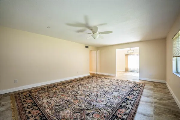 a view of a livingroom with wooden floor and a ceiling fan