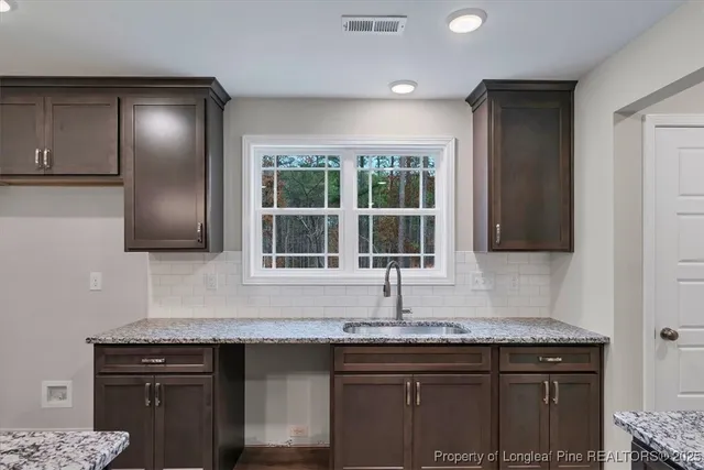 a bathroom with a double vanity sink toilet and a mirror