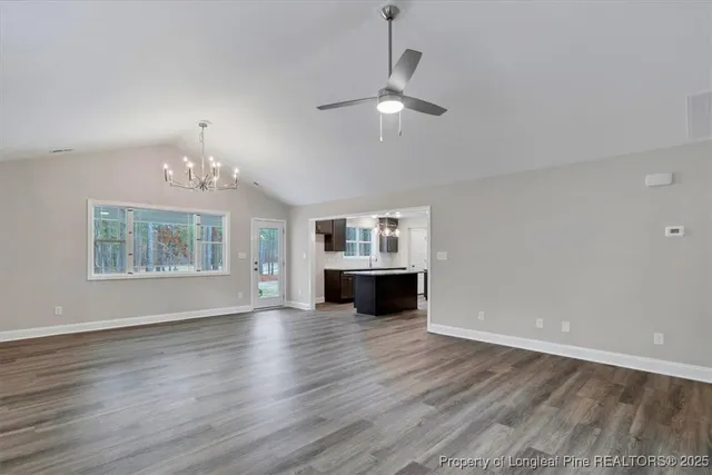 a view of a room with wooden floor and white walls