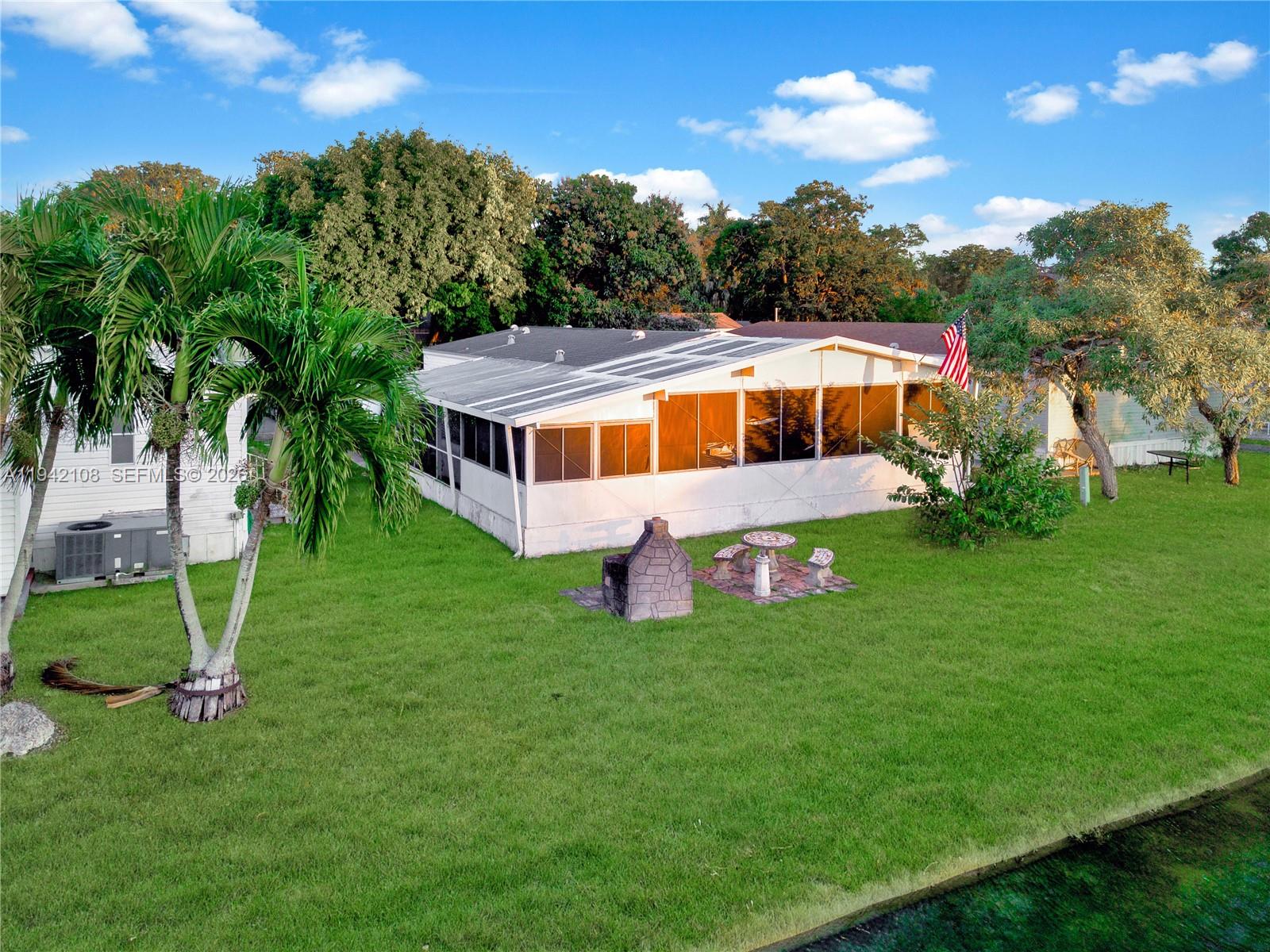 a aerial view of a house with a yard table and chairs
