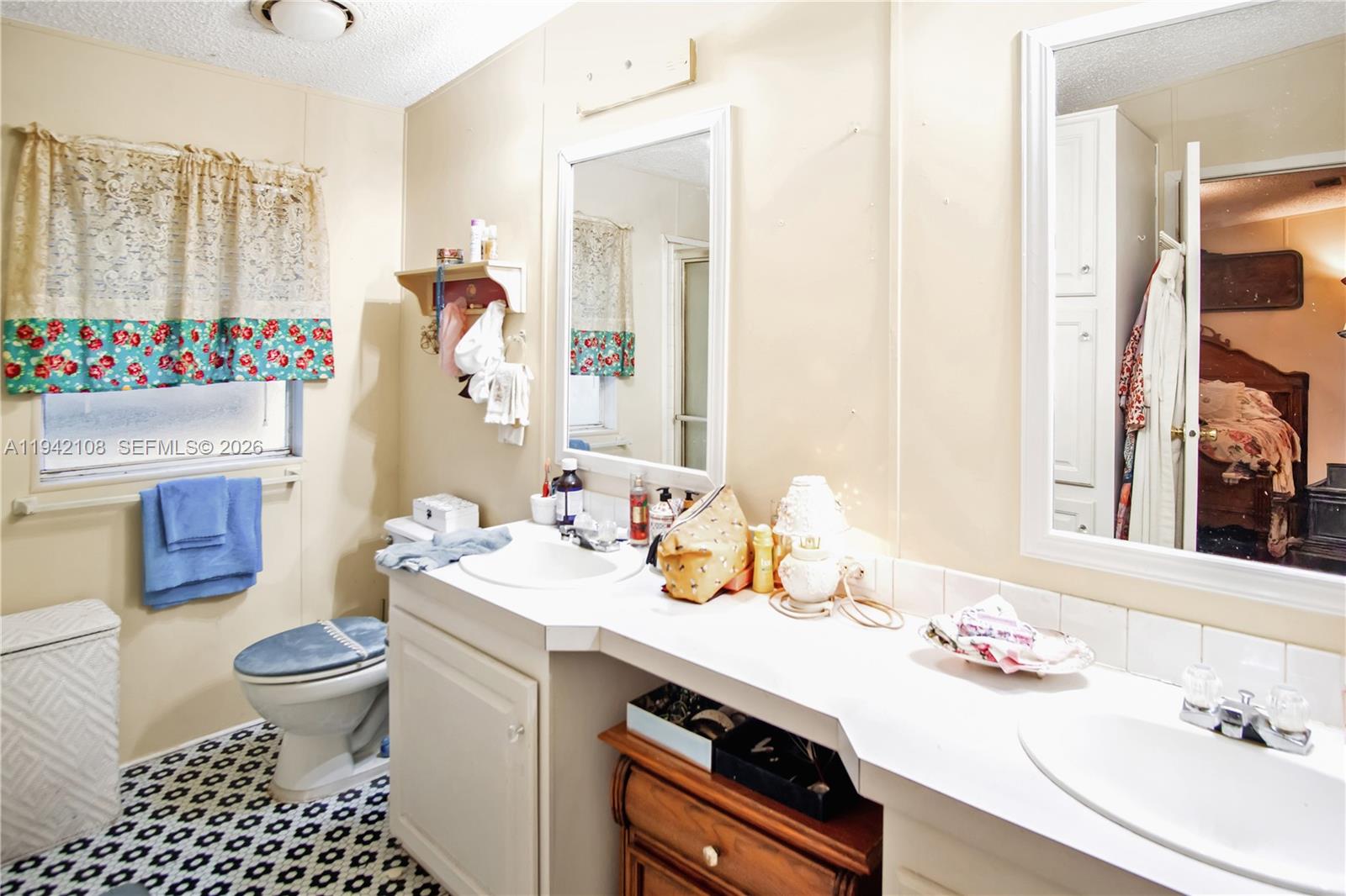 35250 Southwest 177th Court, Unit 48 Homestead, FL 33034 - Photo 12 of 29 a bathroom with a sink a toilet and a mirror