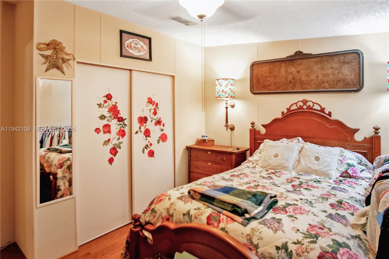 35250 Southwest 177th Court, Unit 48 Homestead, FL 33034 - Photo 13 of 29 a bedroom with a bed and a painting on the wall