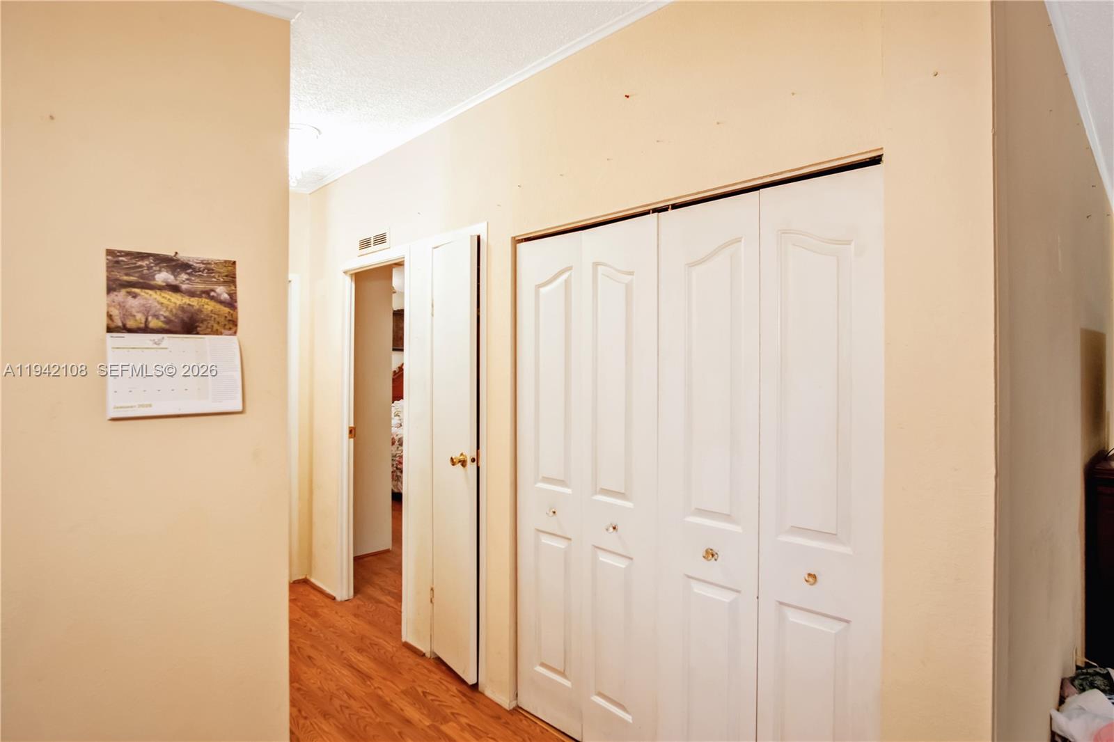 35250 Southwest 177th Court, Unit 48 Homestead, FL 33034 - Photo 14 of 29 a view of a hallway with wooden floor and entryway