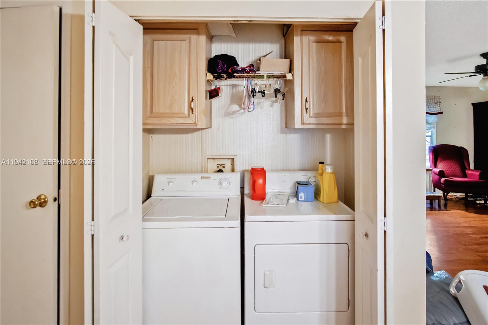 35250 Southwest 177th Court, Unit 48 Homestead, FL 33034 - Photo 15 of 29 a utility room with dryer washer and a view of living room