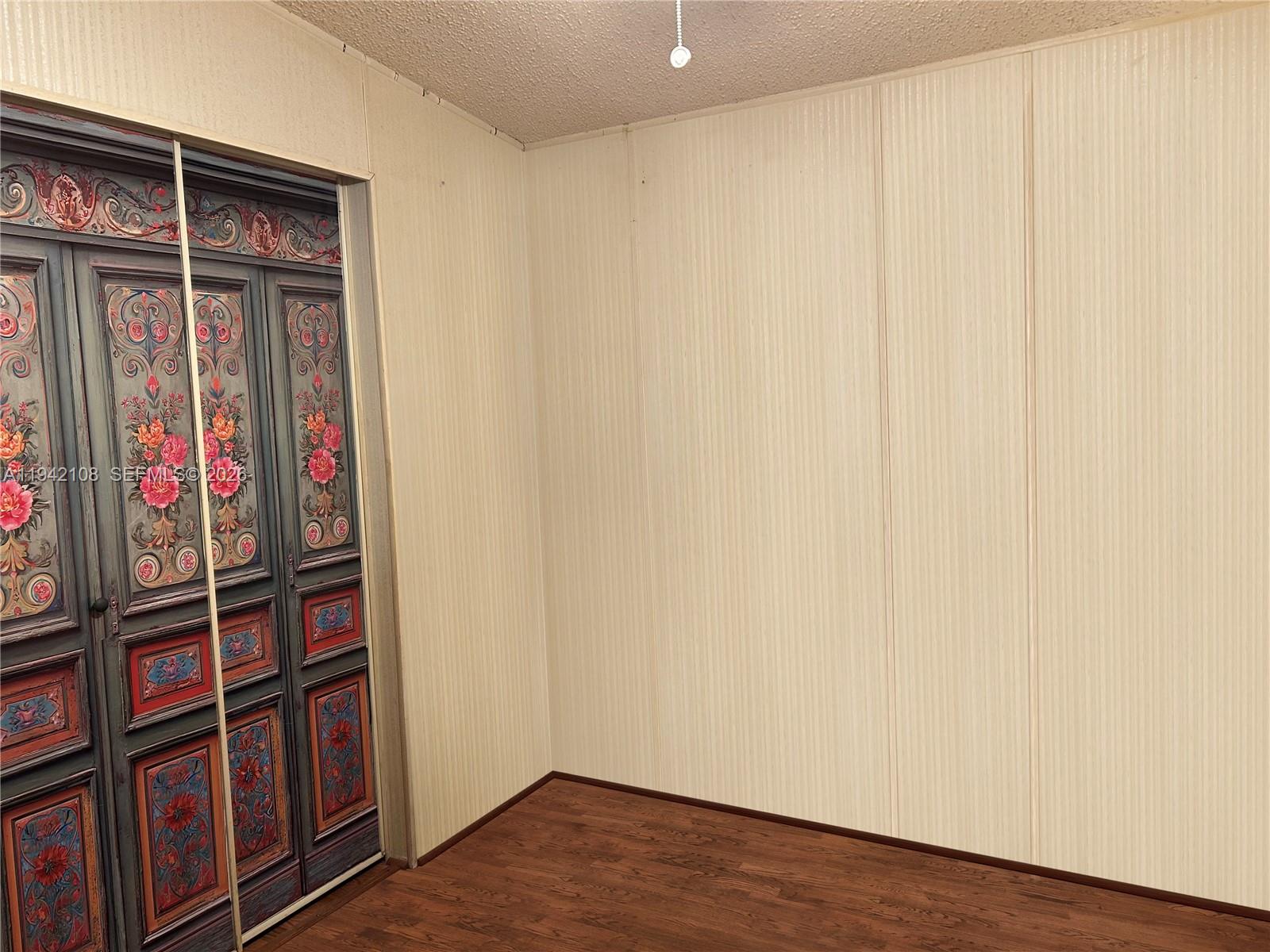 35250 Southwest 177th Court, Unit 48 Homestead, FL 33034 - Photo 18 of 29 a view of wooden floor and windows in a room