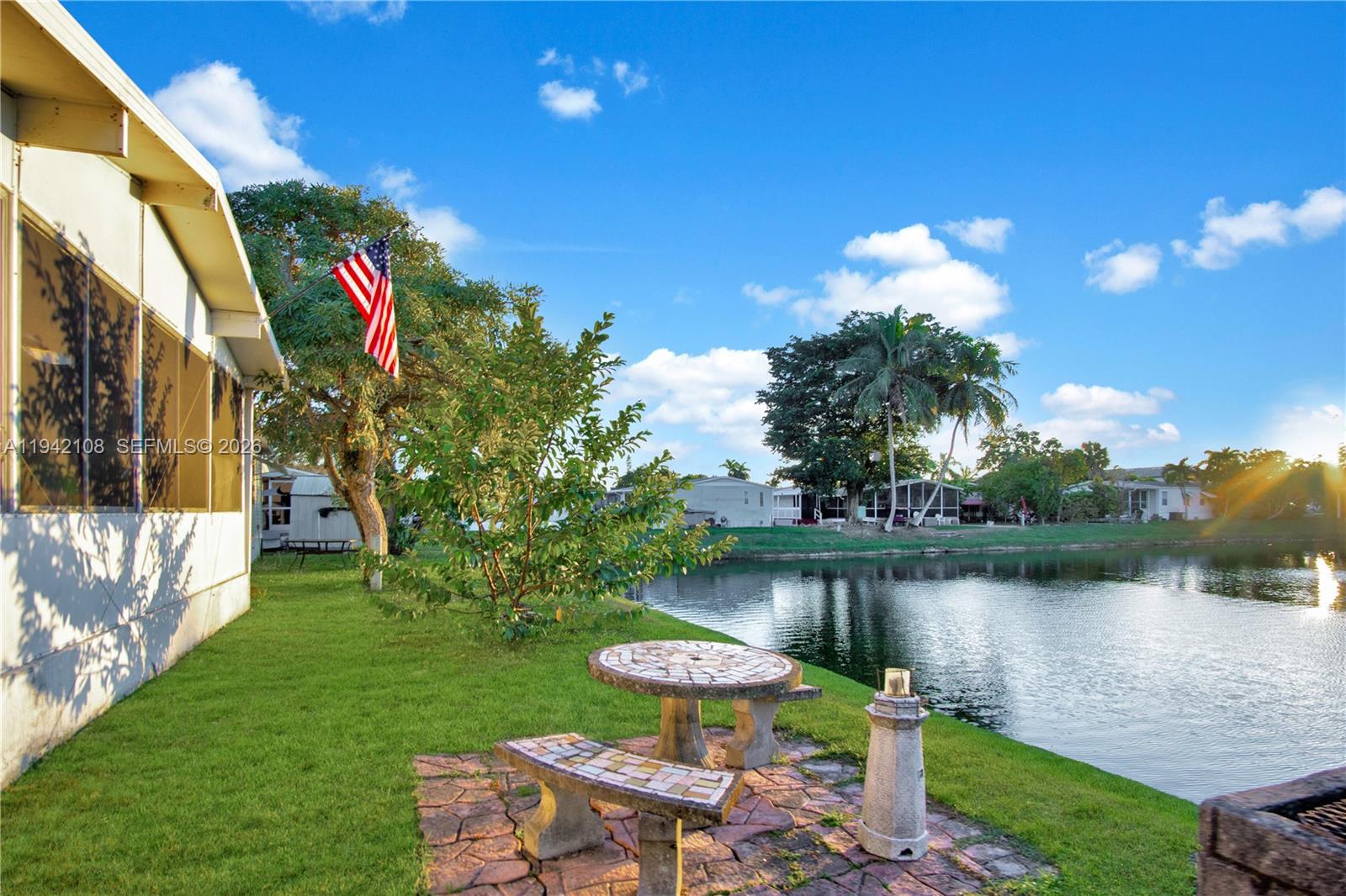 35250 Southwest 177th Court, Unit 48 Homestead, FL 33034 - Photo 2 of 29 a front view of a house with garden and lake view