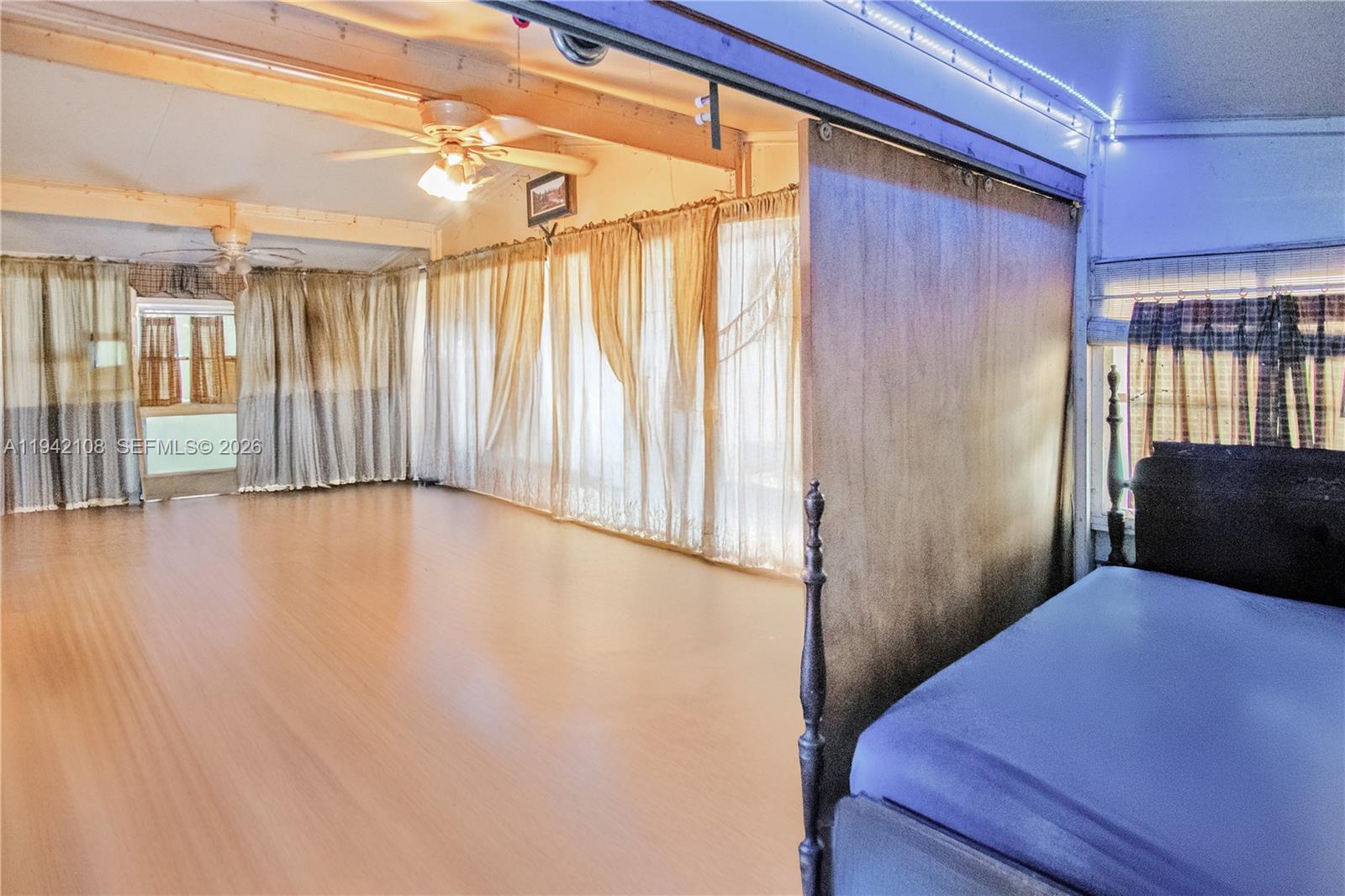 35250 Southwest 177th Court, Unit 48 Homestead, FL 33034 - Photo 22 of 29 a view of hallway with furniture and a window