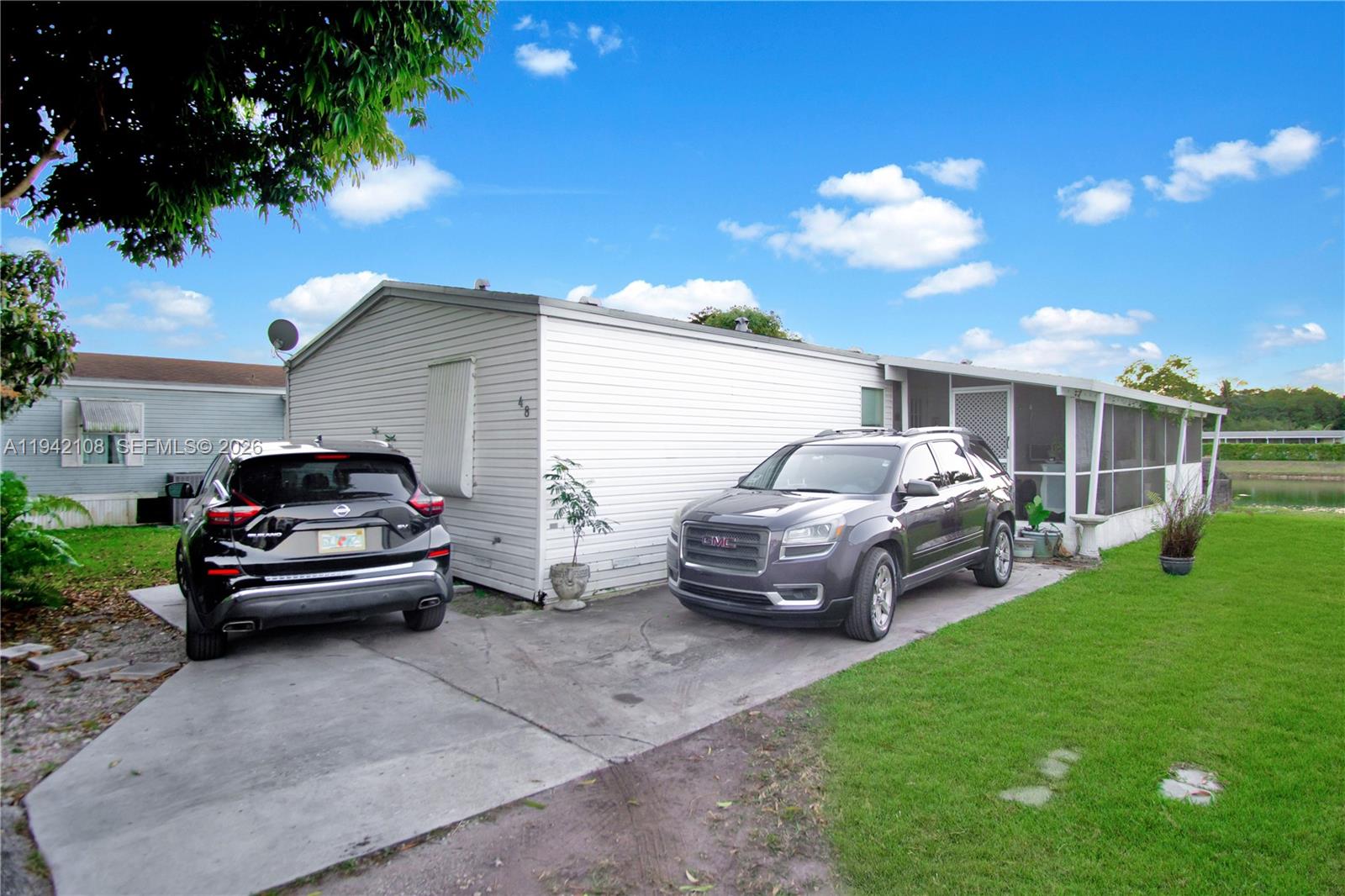 35250 Southwest 177th Court, Unit 48 Homestead, FL 33034 - Photo 29 of 29 a car parked in a yard