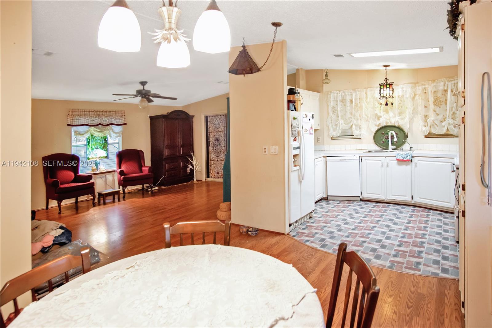 35250 Southwest 177th Court, Unit 48 Homestead, FL 33034 - Photo 5 of 29 a living room with kitchen island furniture and a chandelier
