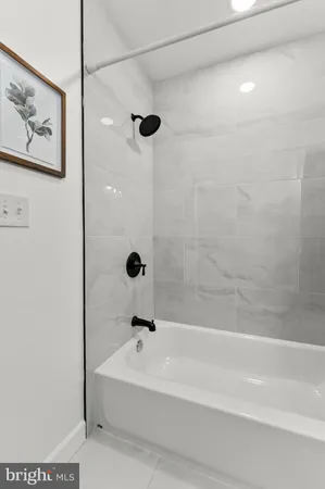a bathroom with a bathtub and shower