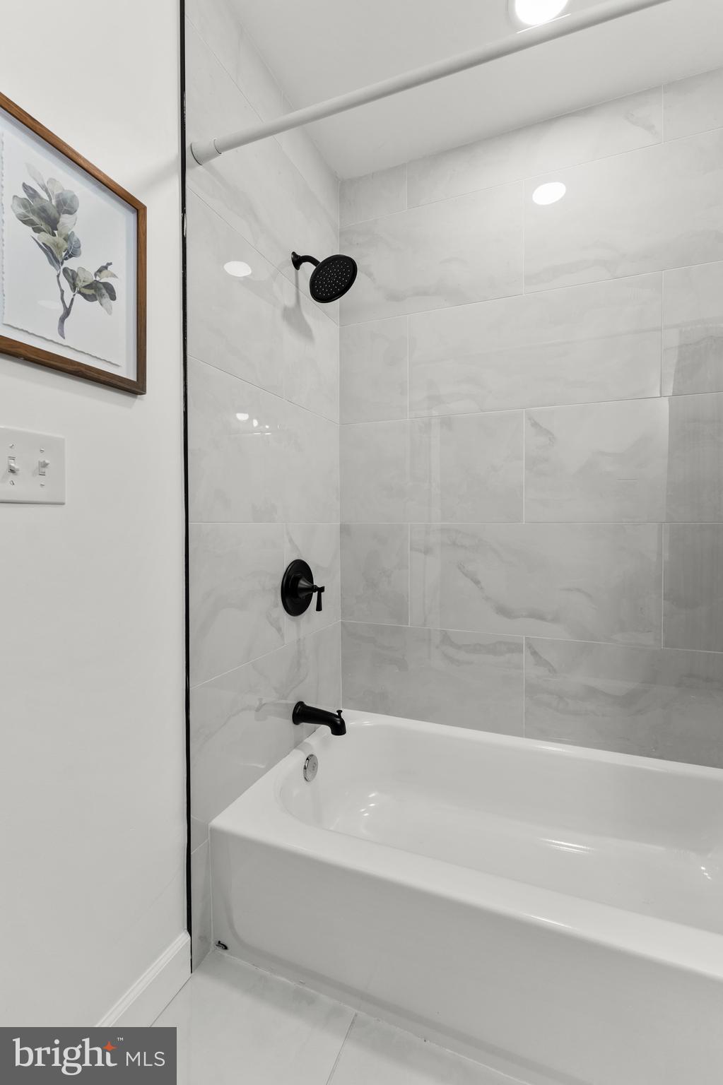 1623 Rutland Avenue Baltimore, MD 21213 - Photo 19 of 38 a bathroom with a bathtub and shower